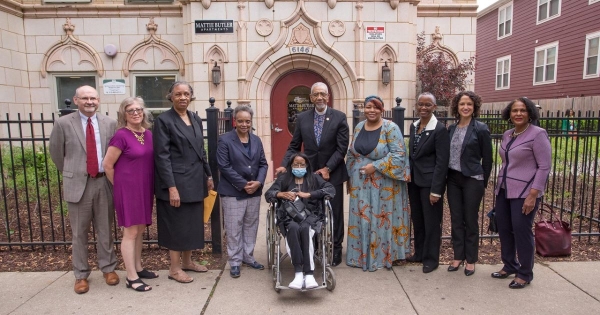 Mattie Butler & others outside building