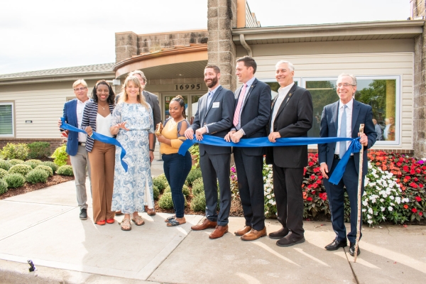 Hawthorne resident Keandra Robinson cuts the ribbon to celebrate the renovation of Hawthorne Place Apartments in Independence, MO.  Joining her for the ceremony are Independence Mayor Rory Rowland, City Manager Zack Walker, Aaron Gornstein, Sevara Davis, Josh Barrett, Jennifer Manulelua with CSL, and Roanoke Construction’s Kevin Buchek and Mike Duffy.