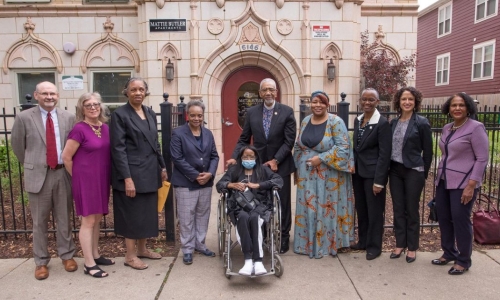 Mattie Butler & others outside building