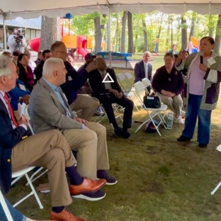 Resident Luz Ramos speaks at event